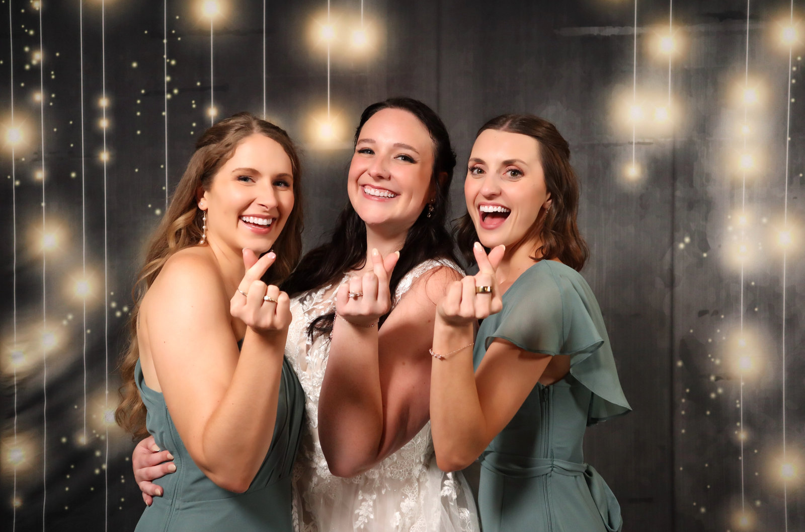Bride and bridesmaids under string lights