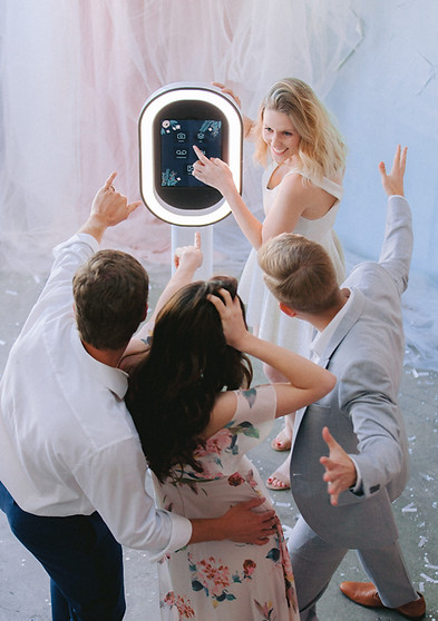 Wedding guests crowding around the iPad booth screen