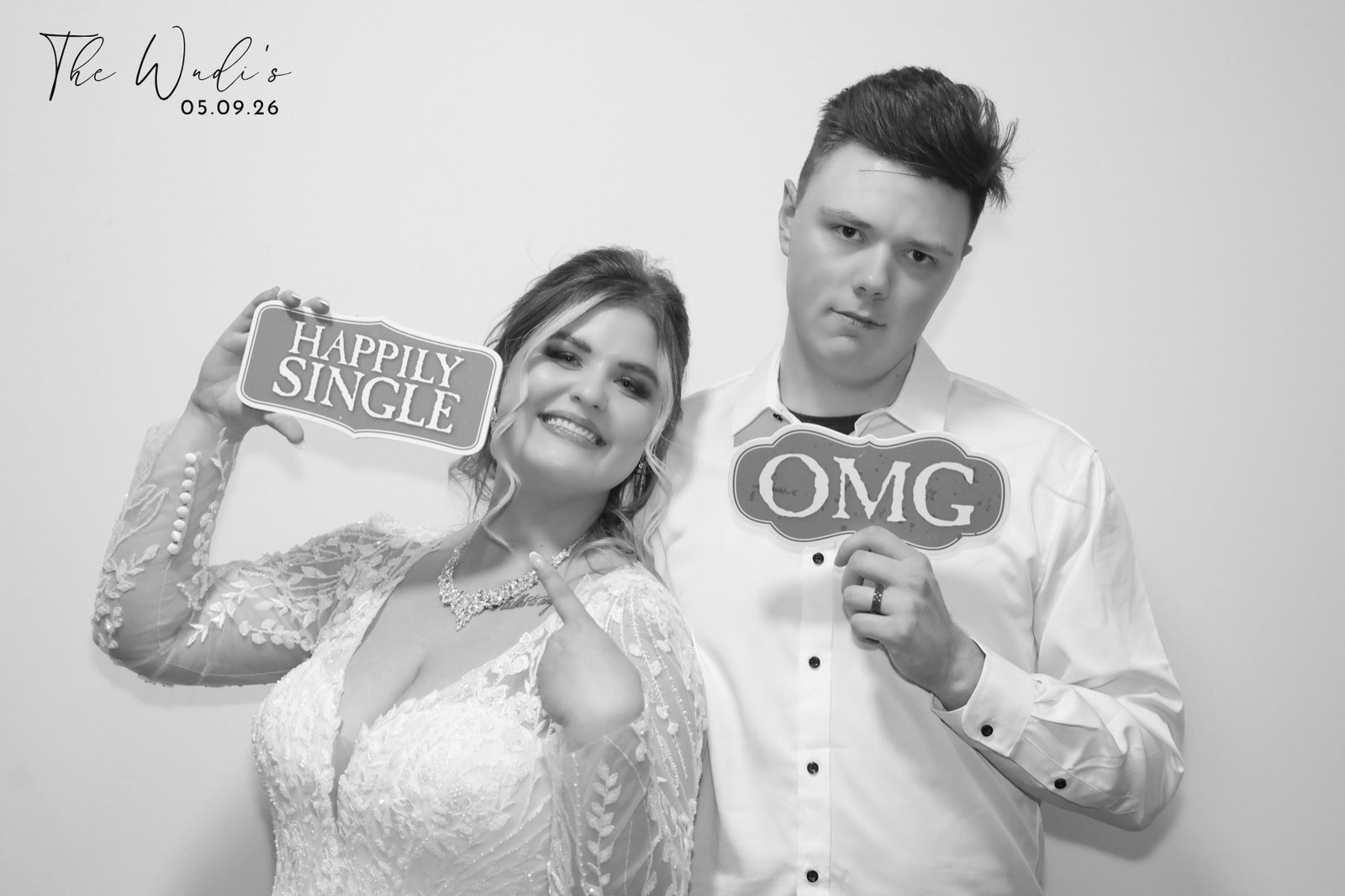 Bride and friend with OMG signs in glowing black and white