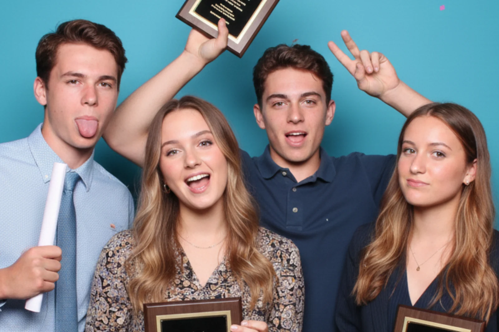 Students celebrating with awards plaques