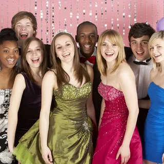 Students dressed for prom at the photo booth (illustration)