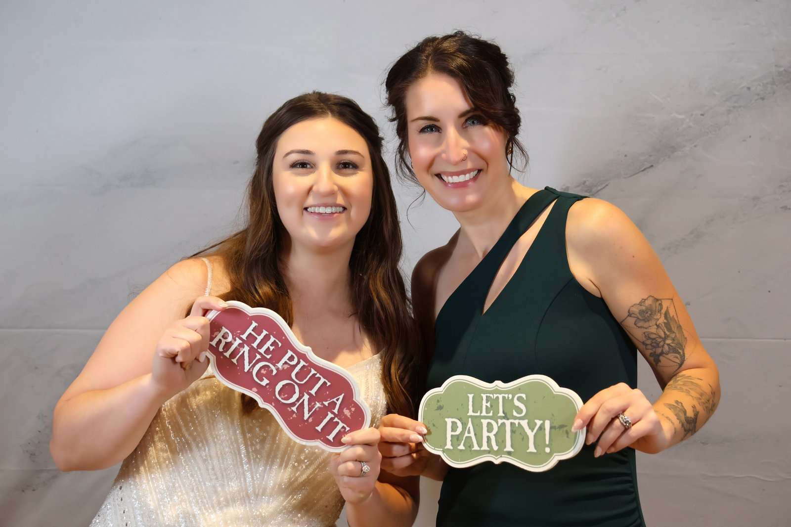 Two friends with Let’s Party signs