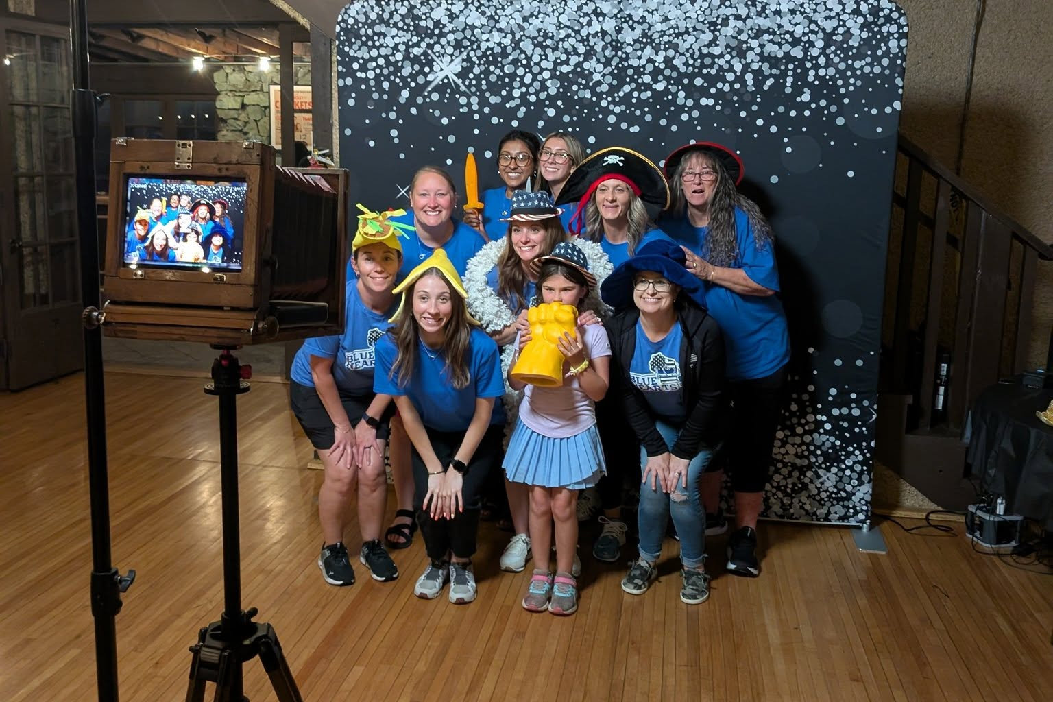 Families and kids crowding into the photo booth at a community event