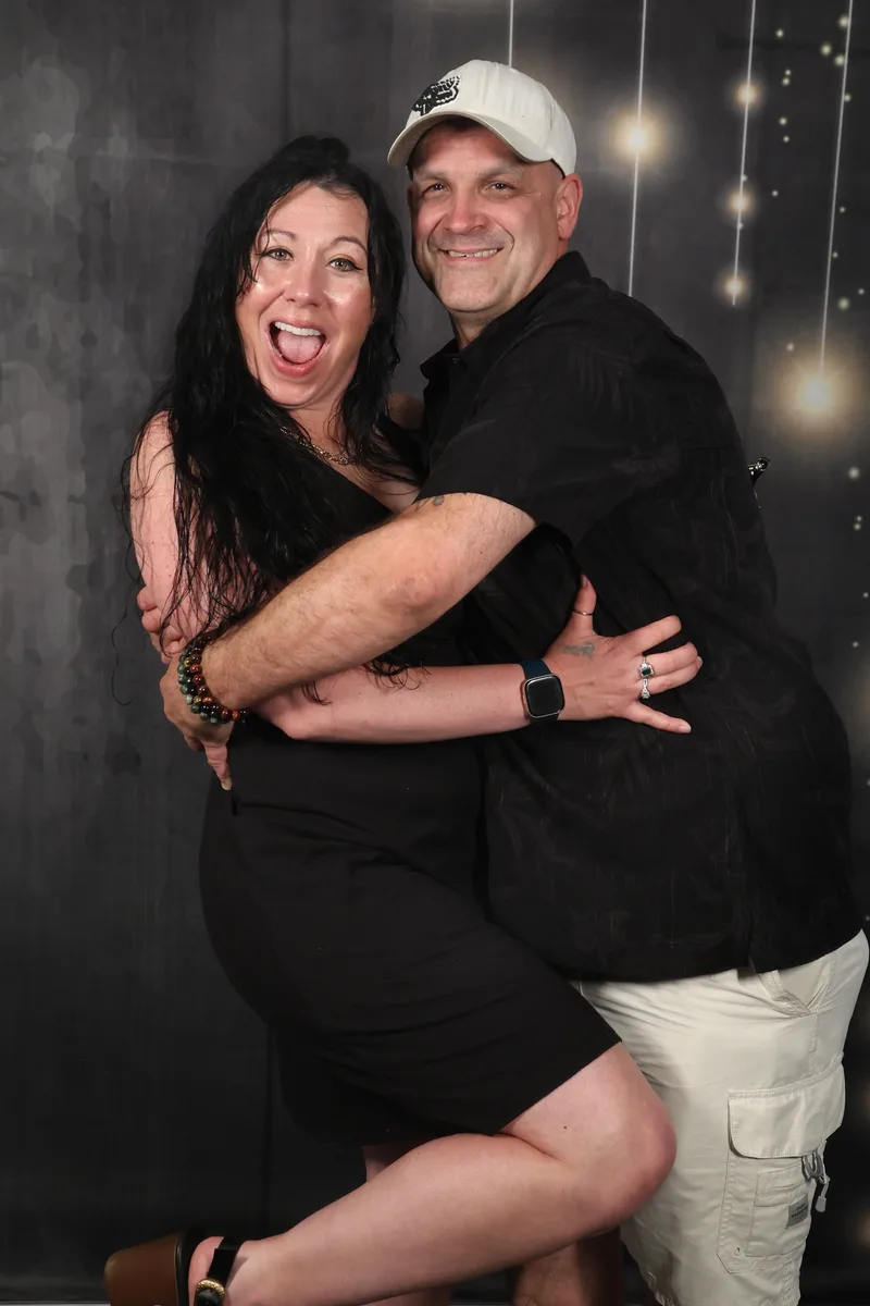 The original booth photo: a couple hugging and laughing